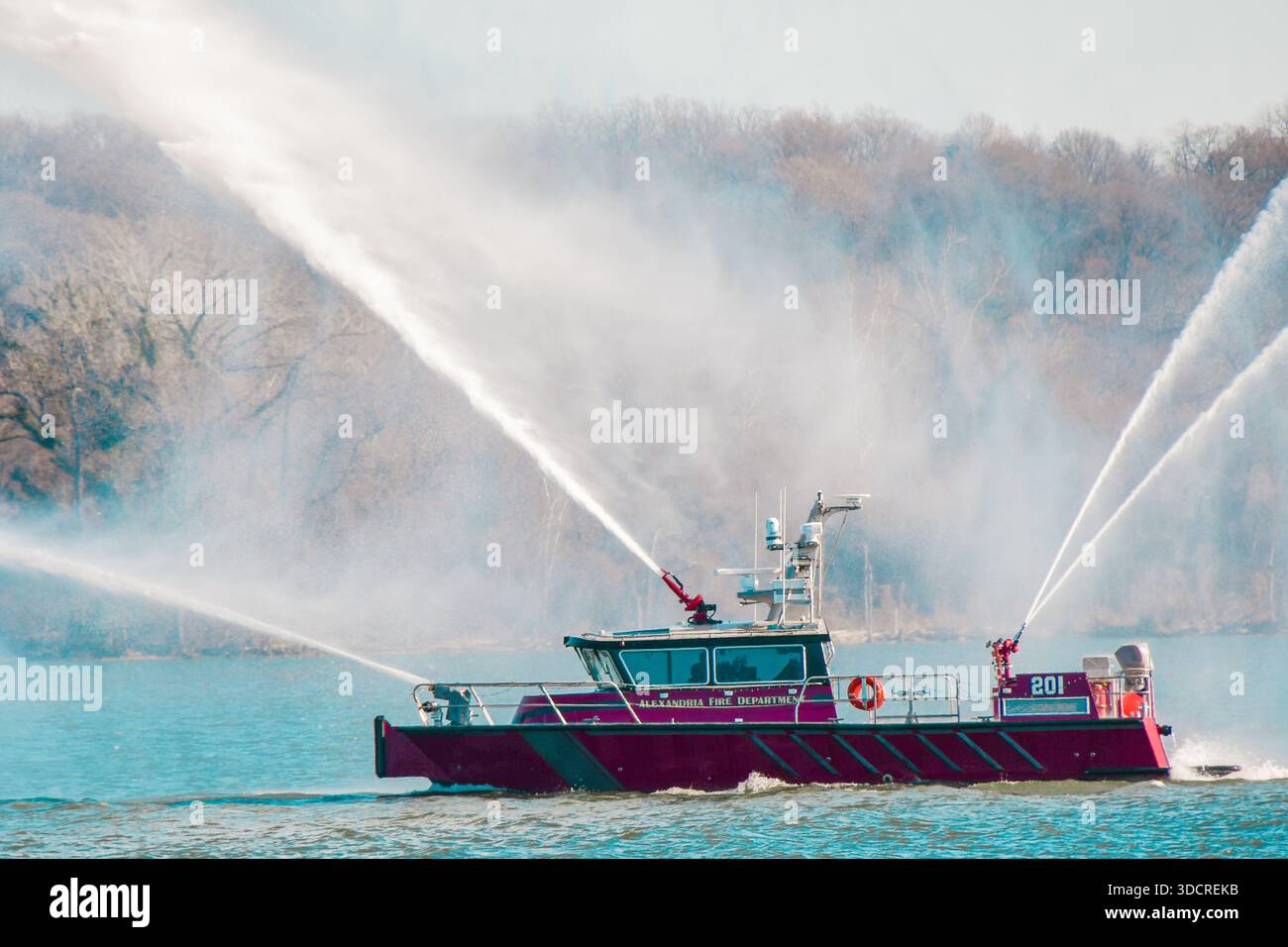 Red fireboat shooting water through all of its firehoses at one time