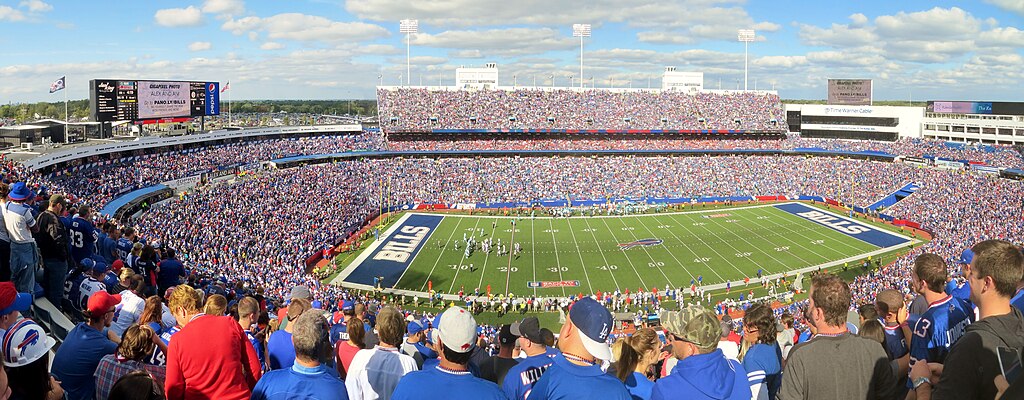Full football stadium in bright sunshine